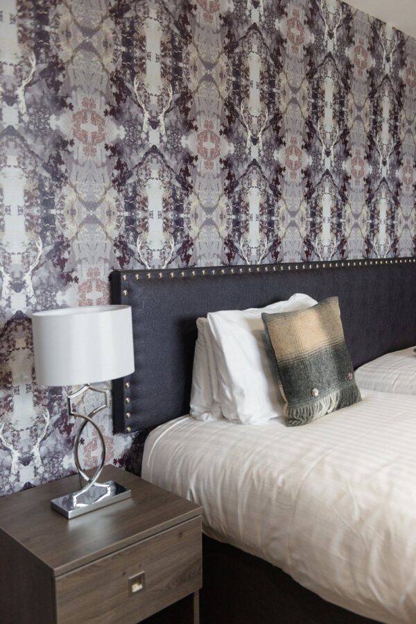 Deer Stalker Wallpaper by Mairi Helena styled in a cozy bedroom