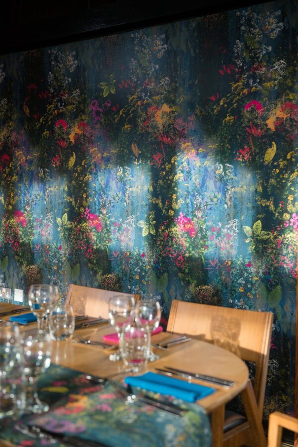 Installation Shot: "Rainfall Blooms wallpaper being hung, showcasing its smooth, high-quality finish and elegant floral pattern.