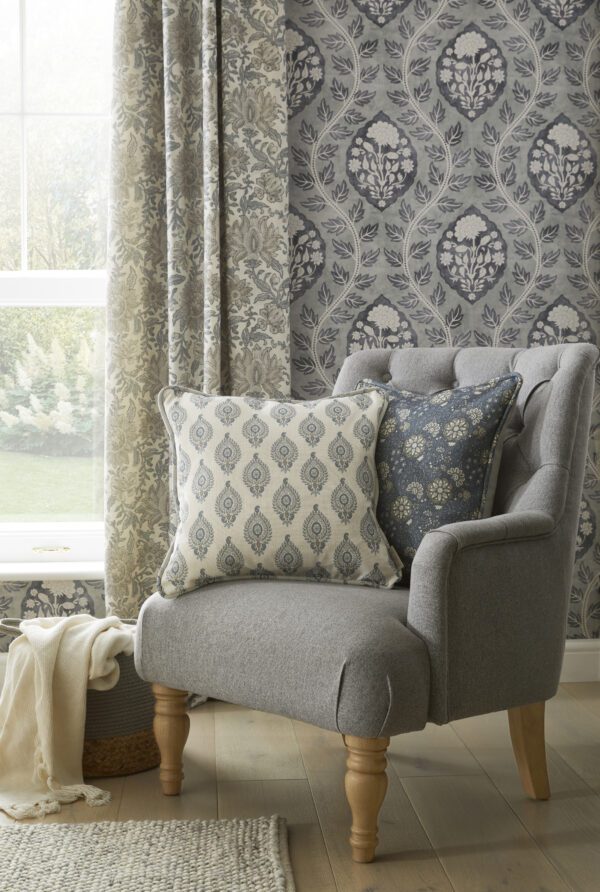 Grey patterened wallpaper and green pattered curtains in a living room